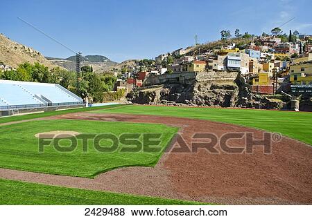 Stock Photo - Baseball park surrounded by old spanish mountainside homes; Guanajuato, Mexico. Fotosearch