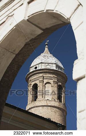 Stock Image - Basilica Di San Vitale turret with dome framed with stone archway; Ravenna, Emilia-Romagna, Italy. Fotosearch