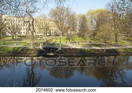 Stock Image - Bastejkalns (Bastion Hill) Reflected In The Pilsetas Canal, Riga, Latvia. Fotosearch
