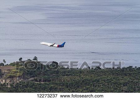 Stock Photo - Batavia Air Boeing 737 taking off from Sentani Airport, Papua, Indonesia. Fotosearch