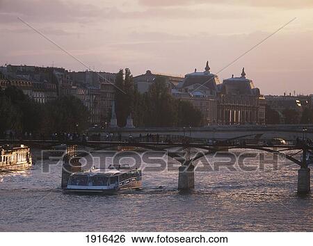 Stock Photograph - Bateau-Mouche On The Seine At Dusk. Fotosearch
