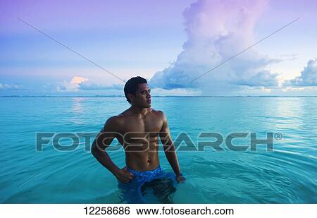 Stock Photograph - Bathing at sunset; Savaii, Samoa. Fotosearch