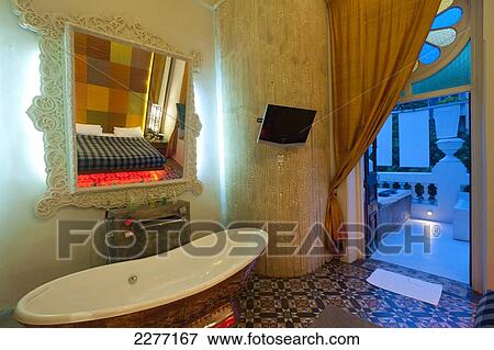 Stock Photo - Bathroom and verandah of Presidential Suite in Casa Colombo Hotel; Colombo, Sri Lanka. Fotosearch