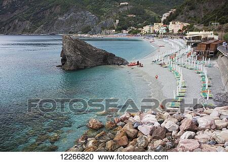 Beach chairs along the water's edge; Monterosso Al Mare, Liguria, Italy View Large Photo Image Stock Image - Beach chairs along the water's edge; Monterosso Al Mare, Liguria, Italy. Fotosearch