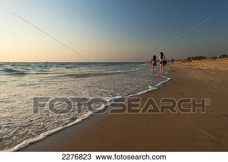 Stock Image - Beach of Candolim at dusk; Candolim, Goa, India. Fotosearch