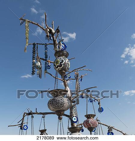 Beaded Jewelry And Lanterns Hanging On Display Against A Blue Sky; Nevsehir Turkey View Large Photo Image Stock Photo - Beaded Jewelry And Lanterns Hanging On Display Against A Blue Sky; Nevsehir Turkey. Fotosearch