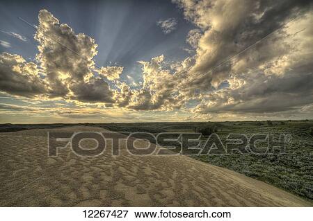 Beams of light from behind a cloud at the Great Sandhills; Saskatchewan, Canada View Large Photo Image Stock Photo - Beams of light from behind a cloud at the Great Sandhills; Saskatchewan, Canada. Fotosearch