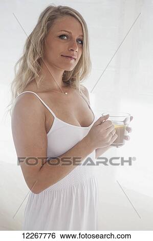 Beautiful blond woman in her bedroom with a cup of tea; Kailua, Island of Hawaii, Hawaii, United States of America View Large Photo Image Stock Photograph - Beautiful blond woman in her bedroom with a cup of tea; Kailua, Island of Hawaii, Hawaii, United States of America. Fotosearch