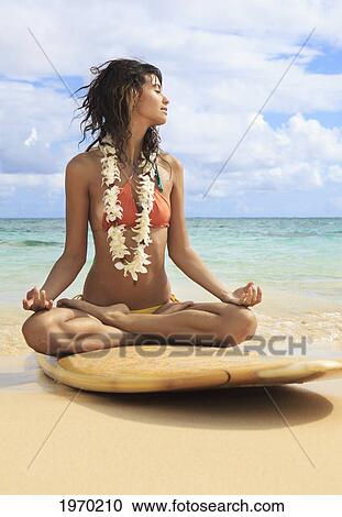 Beautiful Girl Meditating On Her Surfboard View Large Photo Image Stock Image - Beautiful Girl Meditating On Her Surfboard. Fotosearch