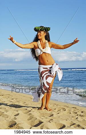 Beautiful Hawaiian girl dancing hula on ocean shoreline View Large Photo Image Stock Photography - Beautiful Hawaiian girl dancing hula on ocean shoreline. Fotosearch