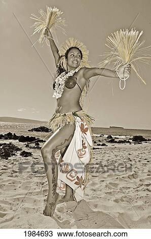 Stock Image - Beautiful Hawaiian Woman Dancing Hula On Ocean Shoreline, Hand Colored.. Fotosearch