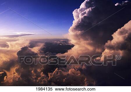 Stock Photography - Beautiful Pink Light From Sunset Glowing On Storm Clouds.. Fotosearch