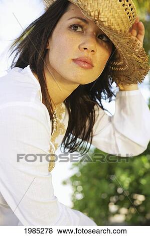 Beautiful Young Woman Wearing A Straw Hat. View Large Photo Image Stock Photo - Beautiful Young Woman Wearing A Straw Hat.. Fotosearch