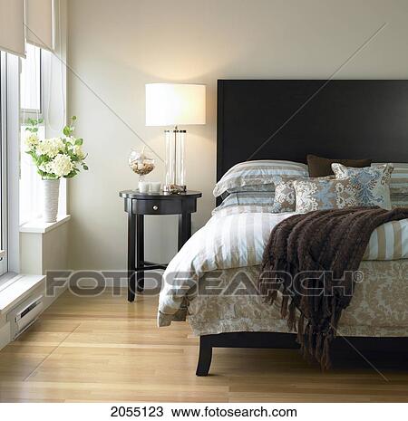 Bedroom With Blue And Brown Bedding, Bedside Table And Hydrangeas In Vase, Victoria, British Columbia View Large Photo Image Stock Image - Bedroom With Blue And Brown Bedding, Bedside Table And Hydrangeas In Vase, Victoria, British Columbia. Fotosearch