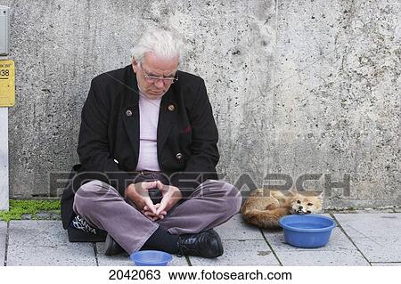 Stock Image - Beggar With A Stuffed Fox, Munich, Bavaria, Germany. Fotosearch