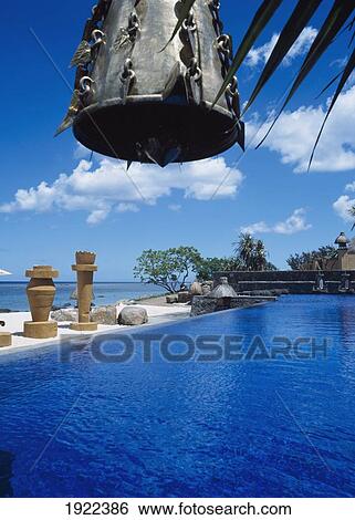 Stock Photograph - Bell Hanging Over Swimming Pool. Fotosearch