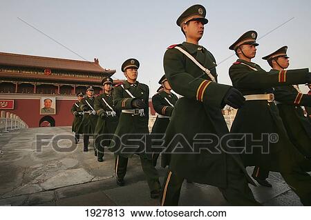 Stock Image - Beneath The Portrait Of Chairman Mao Zedong, Chinese Soldiers Keep Guard Outside The Forbidden City, Tiananmen Square, Beijing, China. Fotosearch