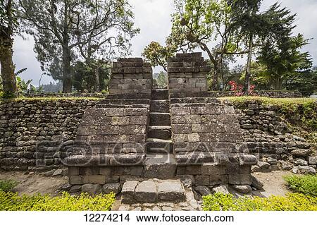 Picture - Bentar gate (gate without roof) flanking a stairway that leads to the third terrace at the 15th-century Javanese-Hindu temple, Candi Sukuh, Central Java, Indonesia. Fotosearch