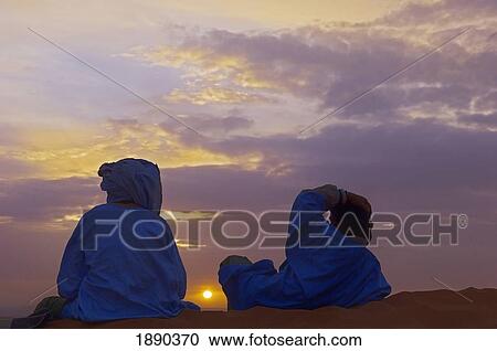 Stock Image - Berber Men Watching Sunrise. Fotosearch