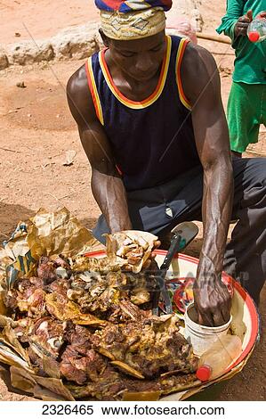 Between Agadez and Niamey; Niger, Street food vendor serving meat by roadside wrapped on scraps of newspaper View Large Photo Image Stock Photography - Between Agadez and Niamey; Niger, Street food vendor serving meat by roadside wrapped on scraps of newspaper. Fotosearch
