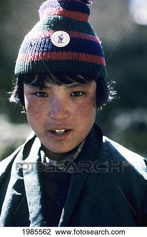 Stock Image - Bhutan, Himayalan Trail, Portrait Of Young Native Boy.. Fotosearch