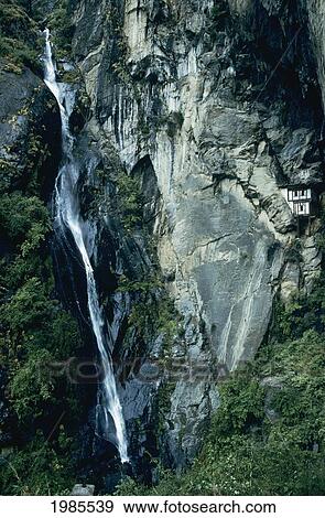 Stock Photo - Bhutan, Paro Valley, Tiger's Nest, Waterfall Cascading Down Rocky Cliff.. Fotosearch
