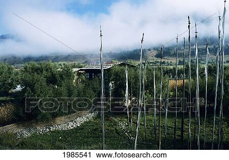 Stock Image - Bhutan, Prayer flags near home; Paro Valley. Fotosearch