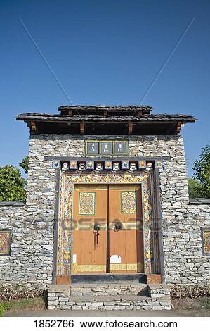Stock Photograph - Bhutanese Painting On A Door In Rock Wall, Bhutan. Fotosearch