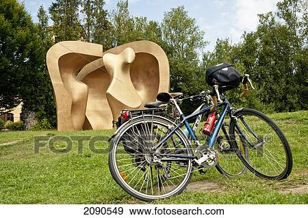 Stock Photo - Bicycle In Front Of, Henry Moore's Sculpture At Parque De Los Pueblos De Europa, Gernika-Lumo, Basque Country, Spain. Fotosearch