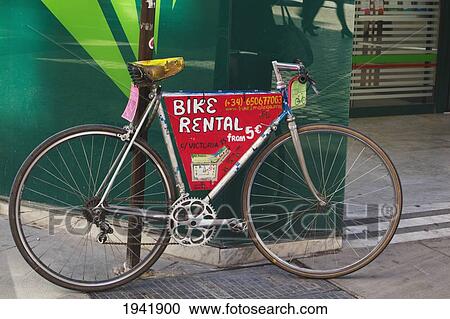 Bicycle Parked In Street Advertising Bike Rentals; Malaga Malaga Province Spain View Large Photo Image Stock Image - Bicycle Parked In Street Advertising Bike Rentals; Malaga Malaga Province Spain. Fotosearch