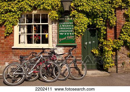 Bicycles Parked In Front Of An Old Inn In Brockenhurst, New Forest National Park, Hampshire, Uk View Large Photo Image Stock Image - Bicycles Parked In Front Of An Old Inn In Brockenhurst, New Forest National Park, Hampshire, Uk. Fotosearch