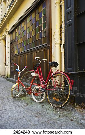 Stock Photo - Bicycles parked outside a residential building in the historical district of the Marais; Paris, France. Fotosearch