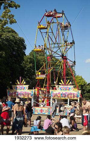 Big Wheel And Festival Goers At Lovebox Festival In Victoria Park, London, Uk View Large Photo Image Stock Image - Big Wheel And Festival Goers At Lovebox Festival In Victoria Park, London, Uk. Fotosearch