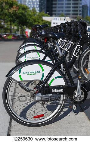 Stock Image - Bike Share bicycles in a row; Toronto, Ontario, Canada. Fotosearch