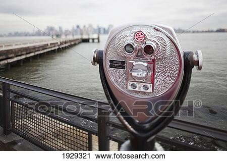 Stock Image - Binoculars looking onto Hudson River; New York City, New York, United States of America. Fotosearch