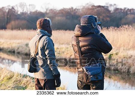 Stock Image - Bird Watchers At Avalon Marshes Of Somerset Levels; Shapwick Heath, Somerset, England, United Kingdom. Fotosearch