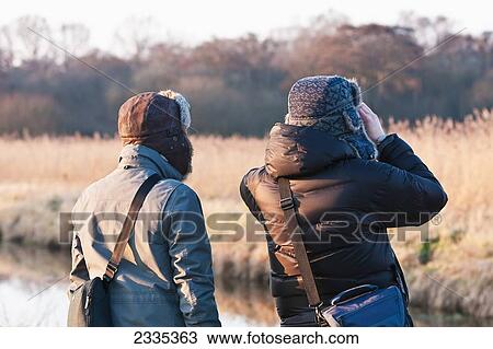 Stock Image - Bird Watchers At Avalon Marshes Of Somerset Levels; Shapwick Heath, Somerset, England, United Kingdom. Fotosearch