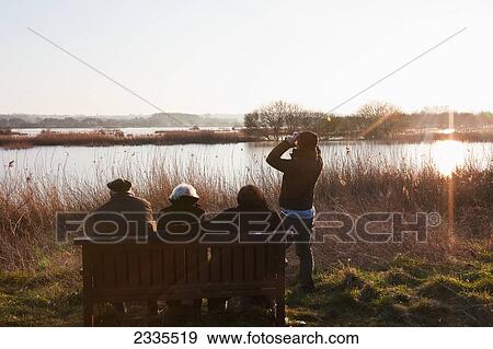 Bird Watchers At Sundown At Shapwick Heath, Wetland Reserve Of Avalon Marshes Of Somerset Levels; Somerset, England, Uk View Large Photo Image Stock Photo - Bird Watchers At Sundown At Shapwick Heath, Wetland Reserve Of Avalon Marshes Of Somerset Levels; Somerset, England, Uk. Fotosearch