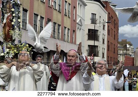Picture - Bishop Of Southwark And Priests Releasing White Doves, Italian Procession, July, Clerkenwell, London, Uk. Fotosearch
