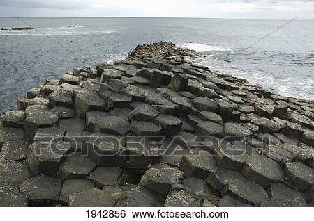 Stock Photograph - Black Basalt Columns Sticking Out Of The Sea, Giant's Causeway, Northern Ireland, United Kingdom. Fotosearch
