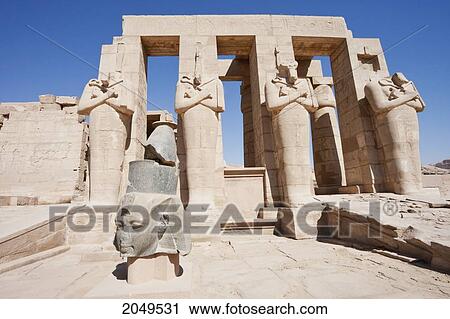 Black Granite Head Of Ramses Ii And Osirid Pillars Of The Temple Of Ramses Ii At The Ramesseum, Western Thebes, Qina, Egypt View Large Photo Image Stock Image - Black Granite Head Of Ramses Ii And Osirid Pillars Of The Temple Of Ramses Ii At The Ramesseum, Western Thebes, Qina, Egypt. Fotosearch
