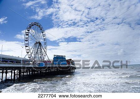 Blackpool central pier reaches out into the sea, Blackpool Pleasure beach; Blackpool, Lancashire, England View Large Photo Image Picture - Blackpool central pier reaches out into the sea, Blackpool Pleasure beach; Blackpool, Lancashire, England. Fotosearch