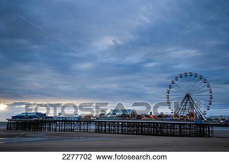 Stock Image - Blackpool central pier reaches out into the sea, Blackpool Pleasure beach; Blackpool, Lancashire, England. Fotosearch