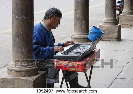 Stock Photo - Blind man playing an organ, Cochabamba, Bolivia. Fotosearch