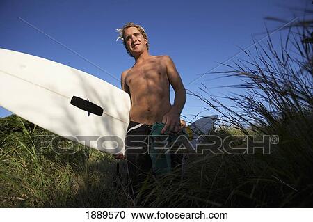 Blond Surfer In Grass Holding Surfboard, Low Angle View View Large Photo Image Stock Image - Blond Surfer In Grass Holding Surfboard, Low Angle View. Fotosearch