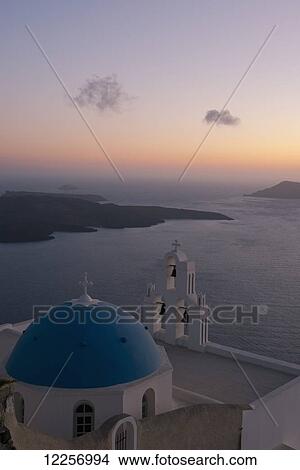 Picture - Blue domed church and bell tower at sunset; Firostefani, Sanotrini, Cyclades, Greek Islands, Greece. Fotosearch