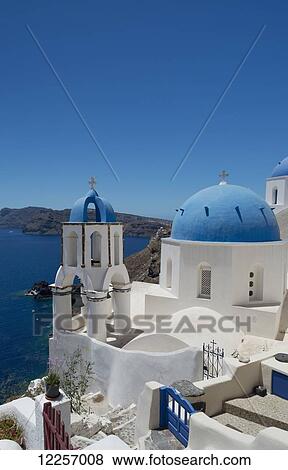 Blue domed churches on a cliff overlooking the caldera; Oia, Santorini, Cyclades, Greek Islands, Greece View Large Photo Image Stock Photo - Blue domed churches on a cliff overlooking the caldera; Oia, Santorini, Cyclades, Greek Islands, Greece. Fotosearch