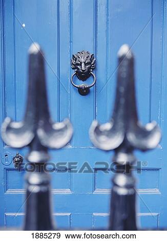 Stock Photo - Blue Door With Lion Door Knocker As Seen Through Iron Fence, London. Fotosearch