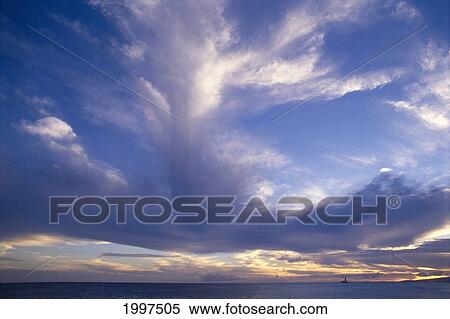 Stock Photography - Blue-Lavender Cloud Formations Over Ocean A35H. Fotosearch