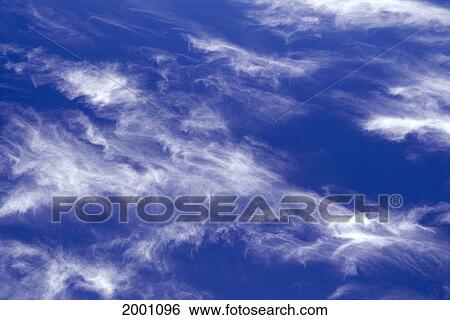 Stock Photograph - Blue Sky Background To Array Of Wispy Clouds In Sky. Fotosearch